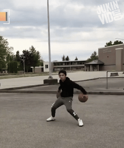 Man Dribbling Basketball In Front Of Sukin Building GIF