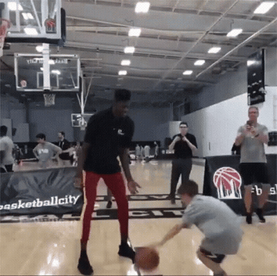 Man Dribbling Basketball Near Basketballcity Sign GIF