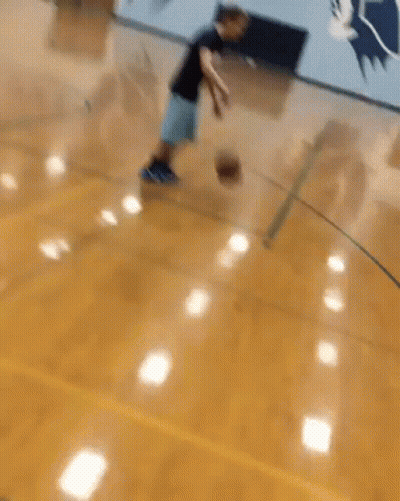 Man Dribbling Basketball Past Defender GIF