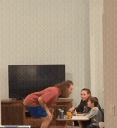 Man Drinking Bottle While Woman And Kids Homework GIF