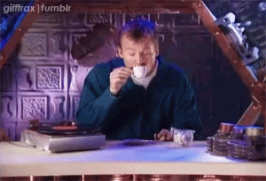 Man Drinking Coffee In Front Of Record Player GIF