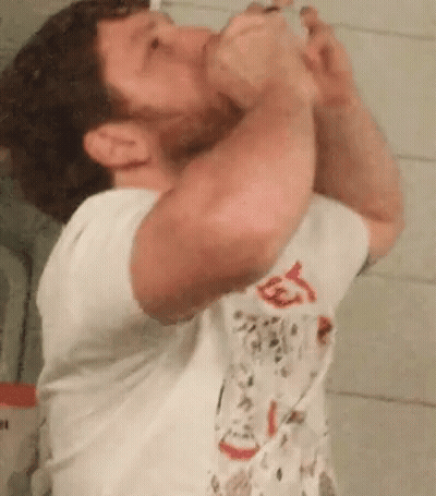 Man Drinking From Bottle In Bathroom GIF