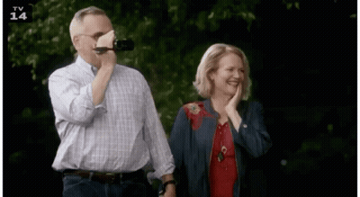 Man Drinking From Bottle While Woman Laughs GIF
