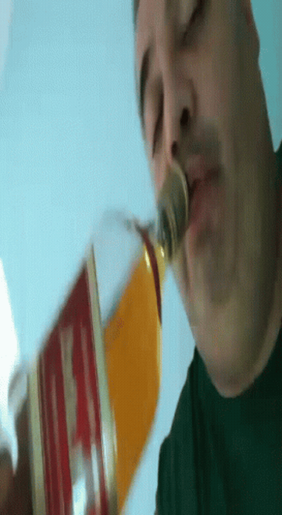 Man Drinking From Glass With Coin In Nose GIF