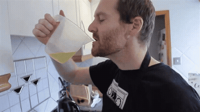Man Drinking From Measuring Cup With Ovo Shirt GIF