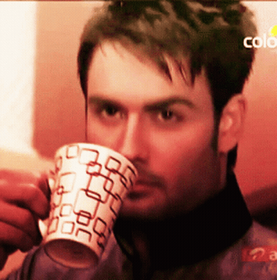 Man Drinking From Mug With Square Pattern GIF