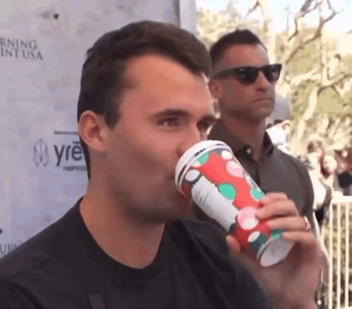 Man Drinking From Polka Dot Cup GIF