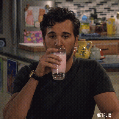Man Drinking Glass With Netflix Logo GIF