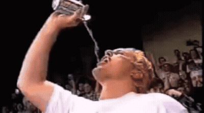 Man Drinking Water From Can While Crowd Watches GIF