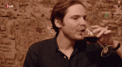 Man Drinking Wine In Front Of 3Sat Graffiti GIF