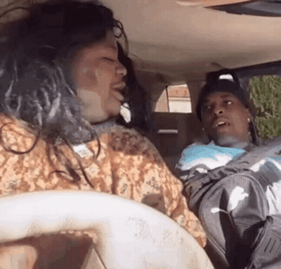 Man Driving As Woman Yawns In Car GIF