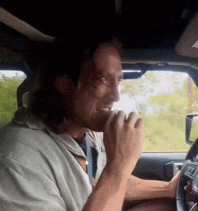 Man Driving Car Eating From Hand GIF