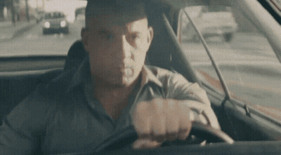 Man Driving Car Looking At Camera GIF