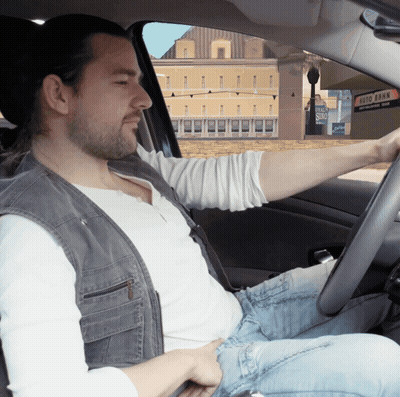 Man Driving Car With Auto Bank Sign GIF