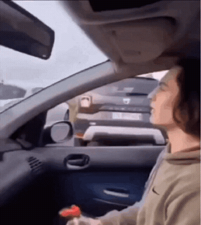 Man Driving Car With Eyes Closed And Bottle GIF