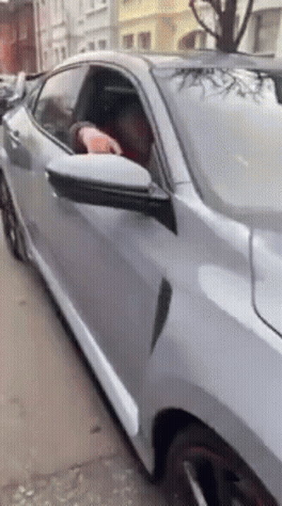Man Driving Car With Head Out Window
