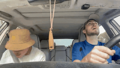 Man Driving Car With Whistle Hanging From Roof GIF