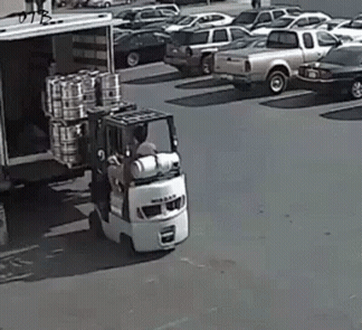 Man Driving Forklift Loading Barrels Into Truck GIF