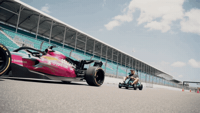 Man Driving Go Kart Next To Crypto.com Race Car GIF