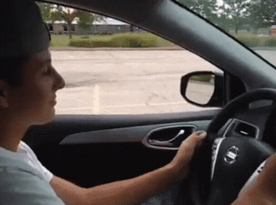 Man Driving Nissan Car And Looking Out Window GIF