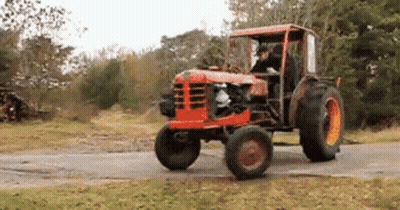 Man Driving Old Red Tractor On Dirt Road GIF