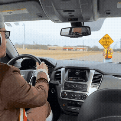 Man Driving Past Yellow Sign Cale Duty Ahead GIF