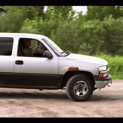 Man Driving Silver GMC Truck GIF