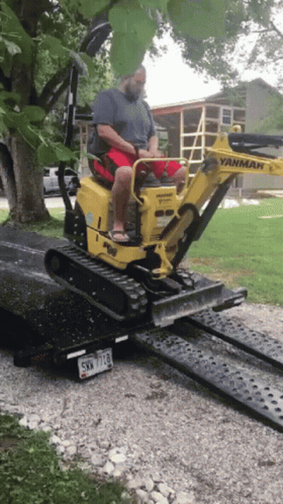 Man Driving Yanmar Excavator On Ramp GIF