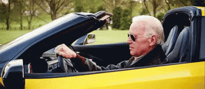 Man Driving Yellow Sports Car Top Down GIF