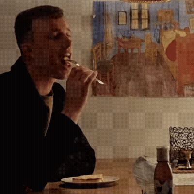 Man Eating Cheese At Table GIF