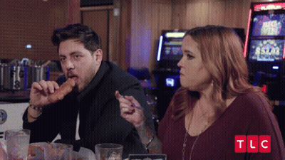 Man Eating Chicken Nugget Woman Looking TLC Logo GIF
