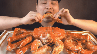 Man Eating Crab And Shrimp GIF