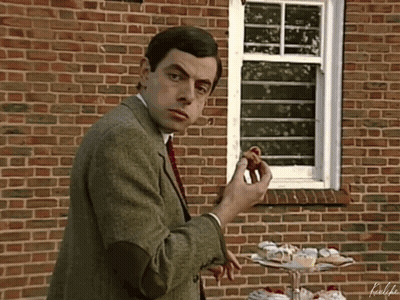 Man Eating Doughnut In Front Of Brick Wall GIF