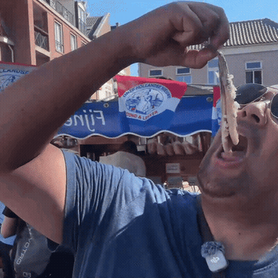Man Eating Food In Front Of Duck Hollandse Streek Sign GIF