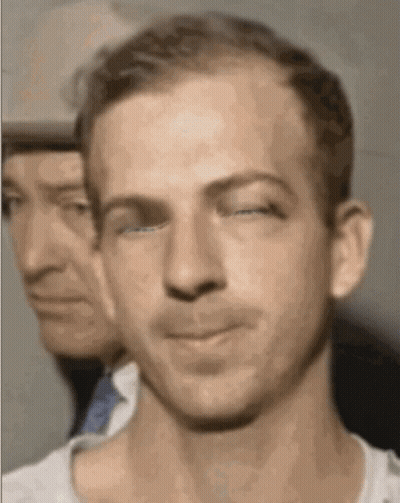 Man Eating Food In Front Of Red Ta Sign GIF