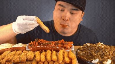Man Eating Fried Food Including Sausage GIF