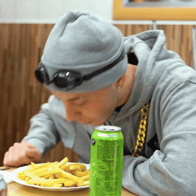 Man Eating Fries Beside Lemonade Can GIF