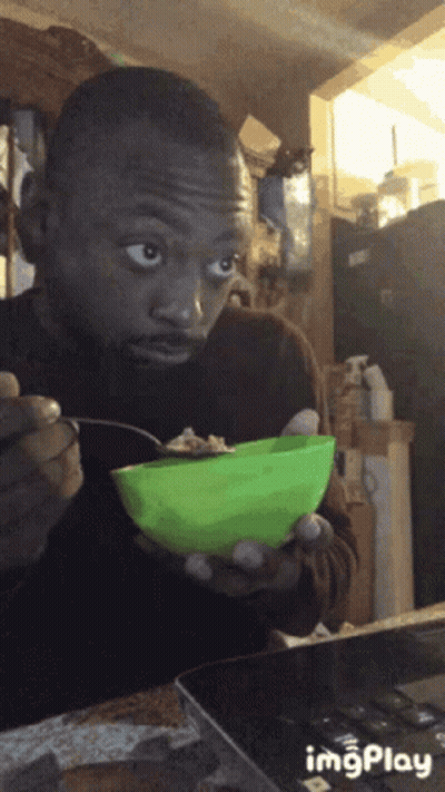 Man Eating From Green Bowl With Spoon GIF