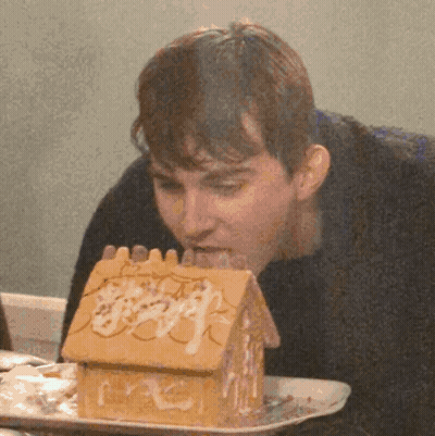 Man Eating Gingerbread House GIF