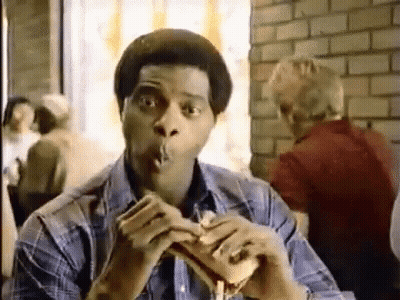 Man Eating Hamburger And Smoking Cigarette GIF