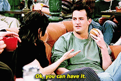 Man Eating Hamburger On Couch Talking To Woman Saying Ok You Can Have It GIF