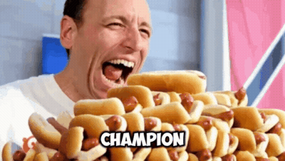 Man Eating Hot Dogs Saying Champion GIF