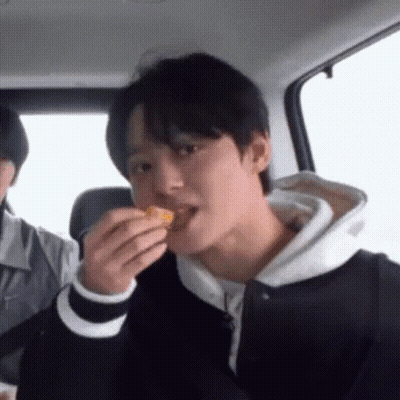 Man Eating In Car While Another Watches GIF