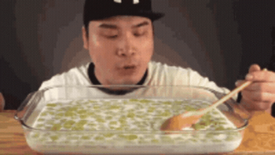 Man Eating Large Amount Of Food With Spoon GIF