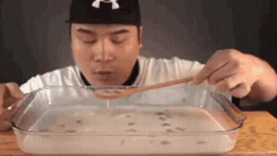 Man Eating Large Amount Of Food With Spoon GIF