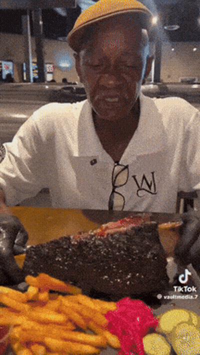 Man Eating Large Piece Of Meat GIF