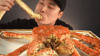 Man Eating Large Red Crab GIF
