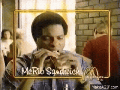 Man Eating McRib Sandwich In Restaurant GIF