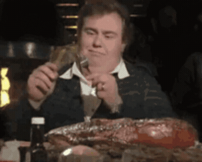 Man Eating Meat Holding Beer GIF