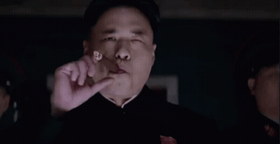 Man Eating Meat In Dark Room With Onlooker GIF